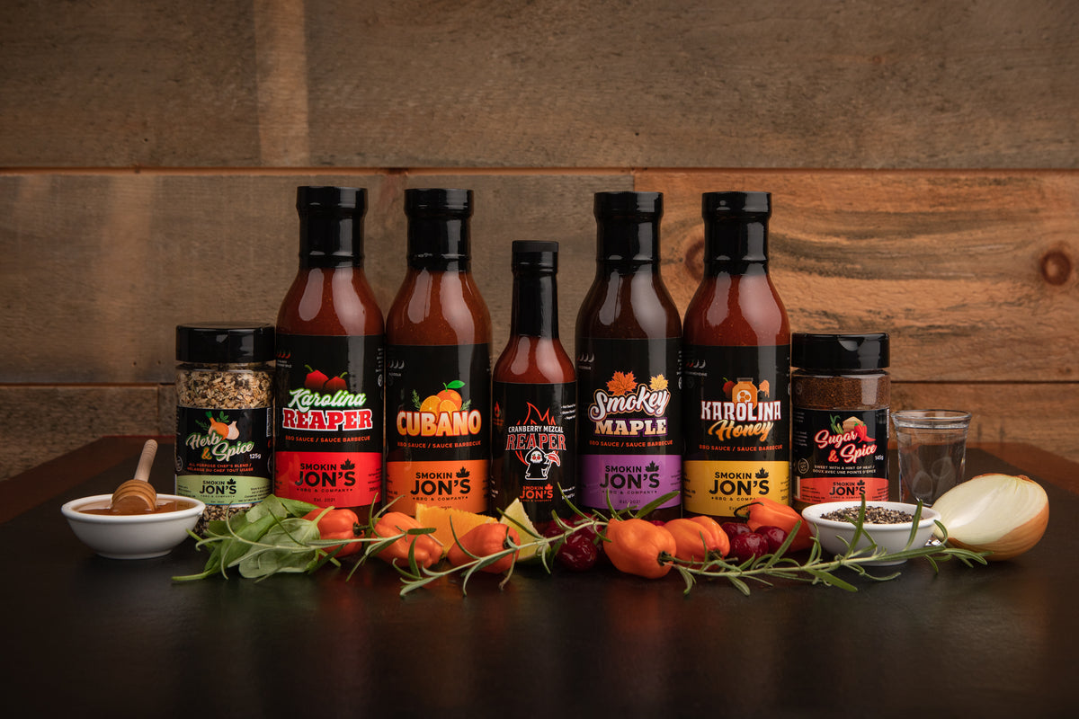 Smokin Jon's BBQ sauces, spices and jerky arranged on a rustic table